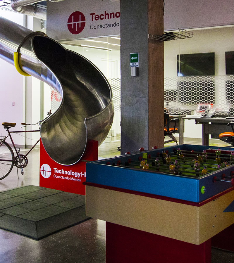 Indoor slide and foosball table at Technology HUB