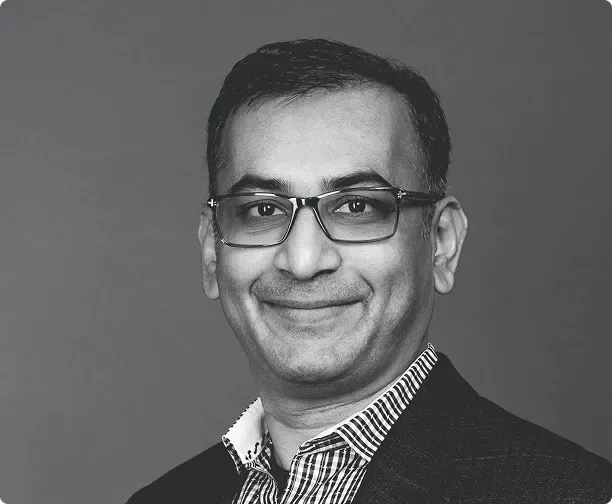 TechWish founder and CEO Vishnu Reddy, wearing glasses and a checked shirt