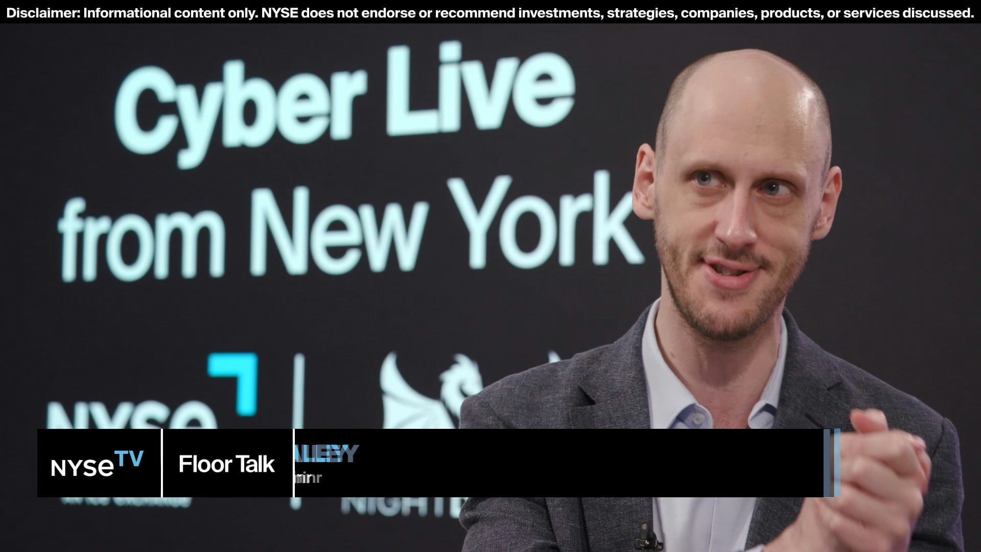 Ted Bailey speaking during an interview on NYSE TV, with a Cyber Live backdrop