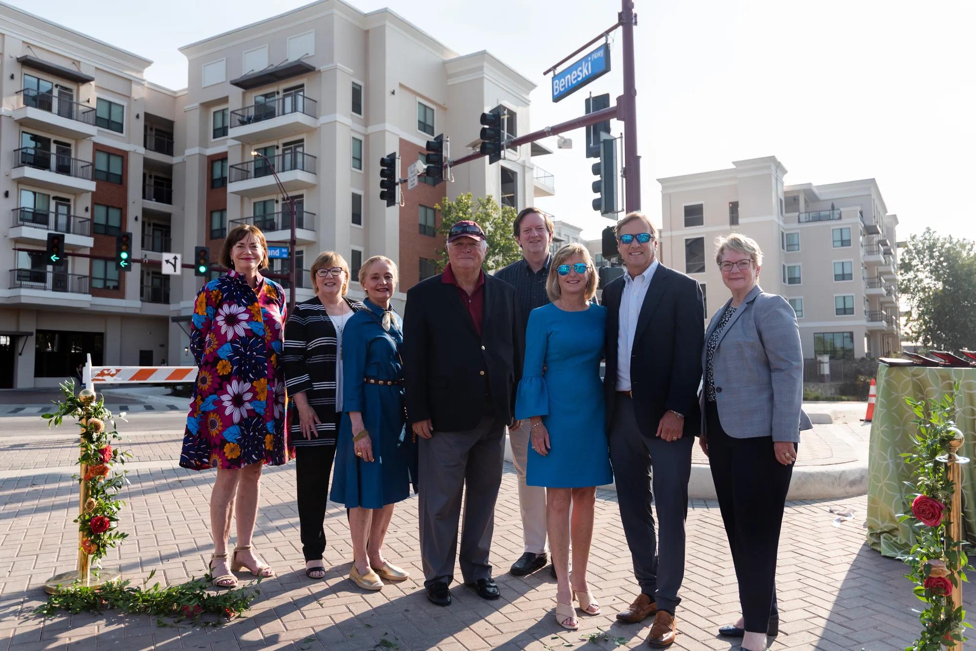Ted and Laurie Beneski with Trinity representatives beneath the Beneski Parkway street sign