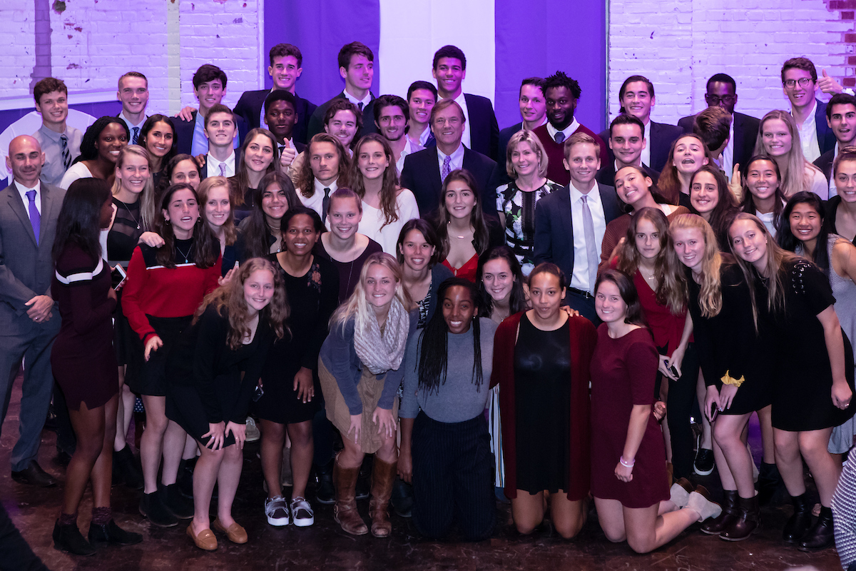 Ted and Laurie Beneski among Amherst soccer players at the 2018 reception