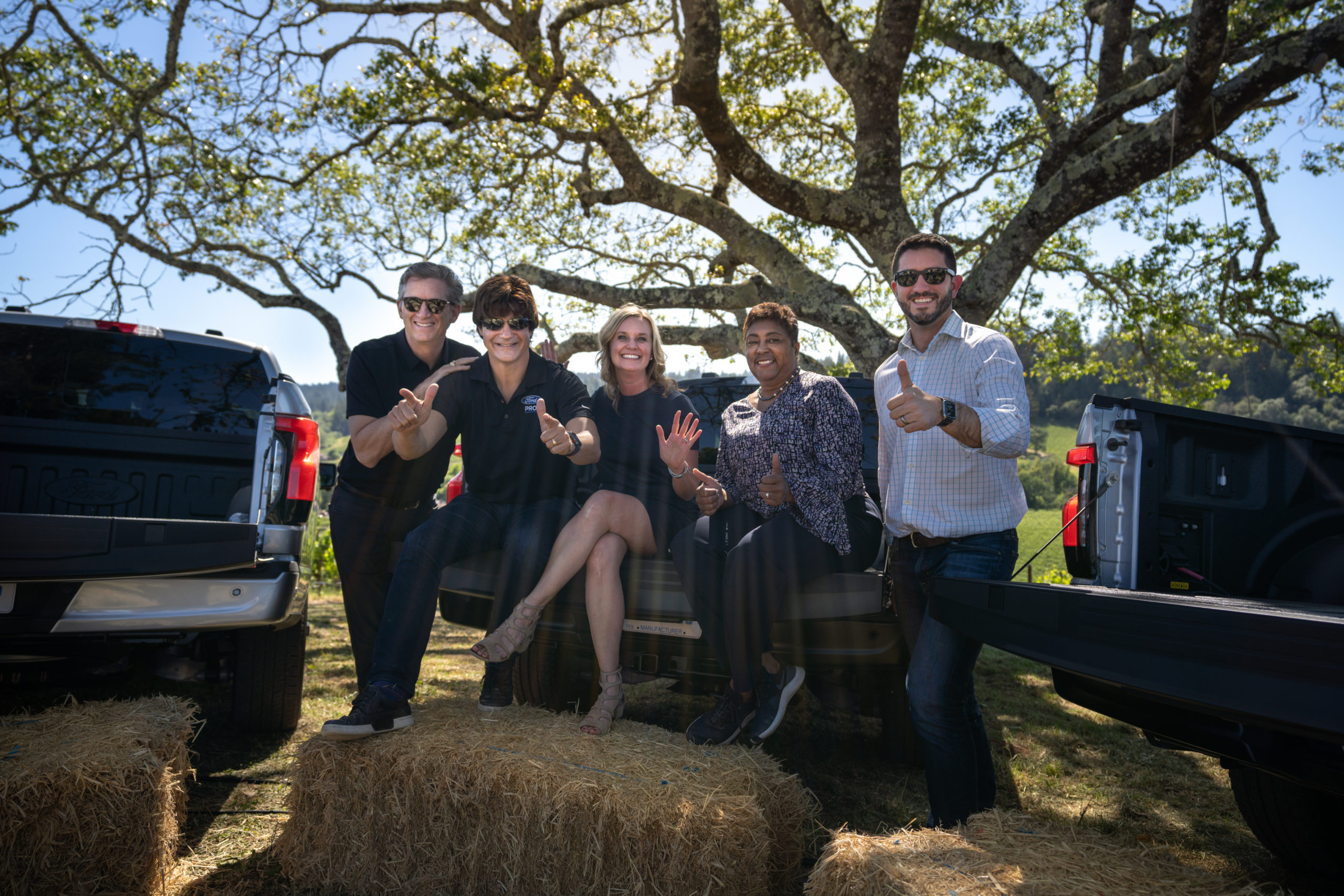 Ted Cannis, second from left, with four other participants between pickup trucks beneath a tree at a Sonoma Ford Pro event