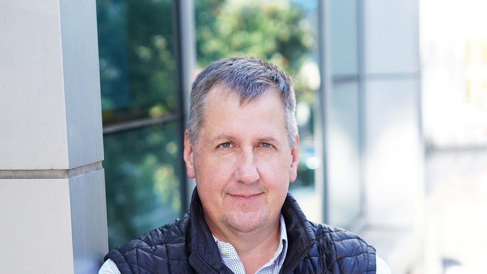 Ted Elliott standing outside a modern office building