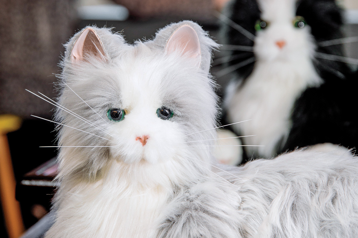 Silver and black-and-white Joy for All companion cats