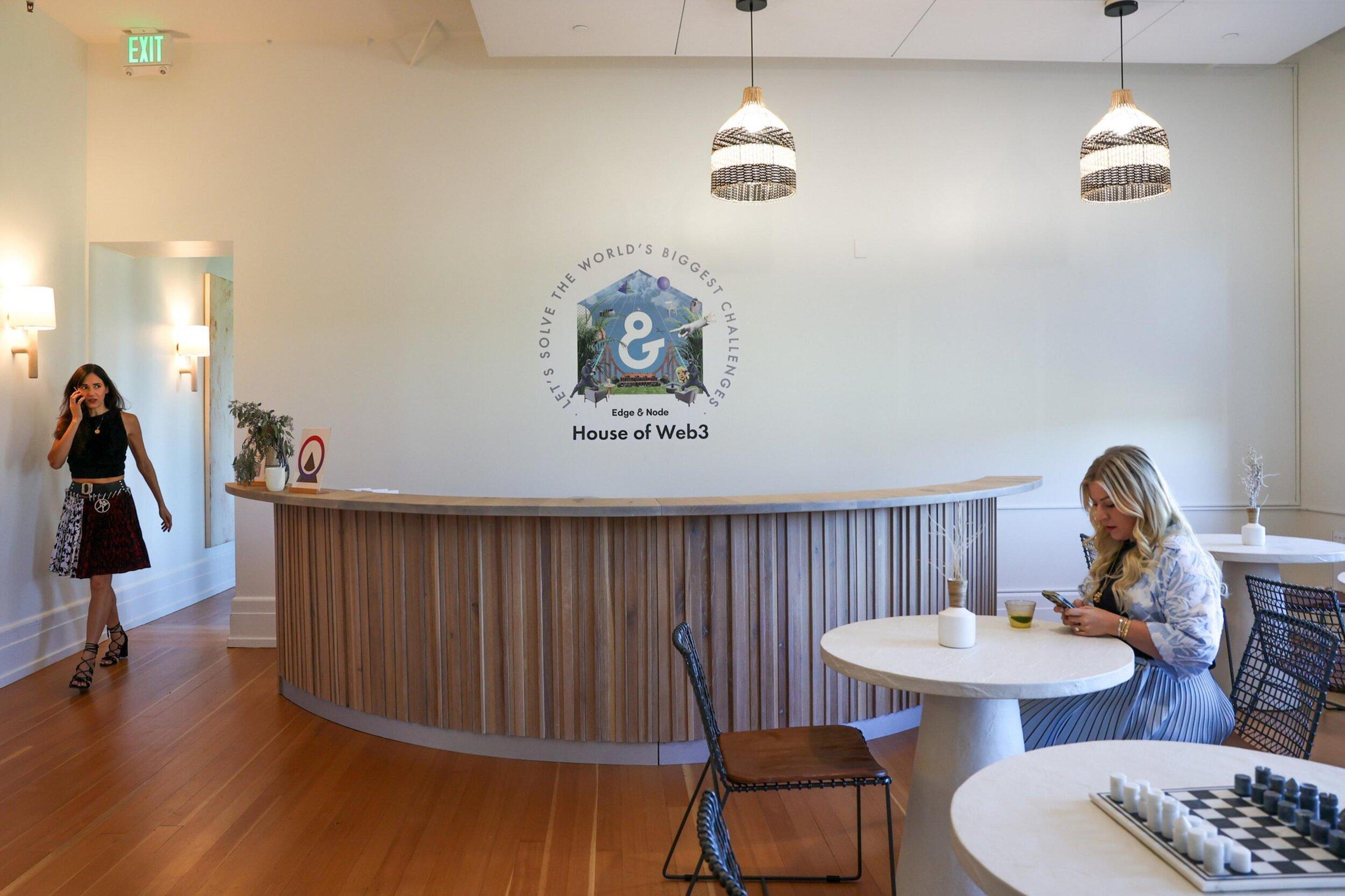 Tegan Kline, right, sitting at a cafe table in the House of Web3 in San Francisco.