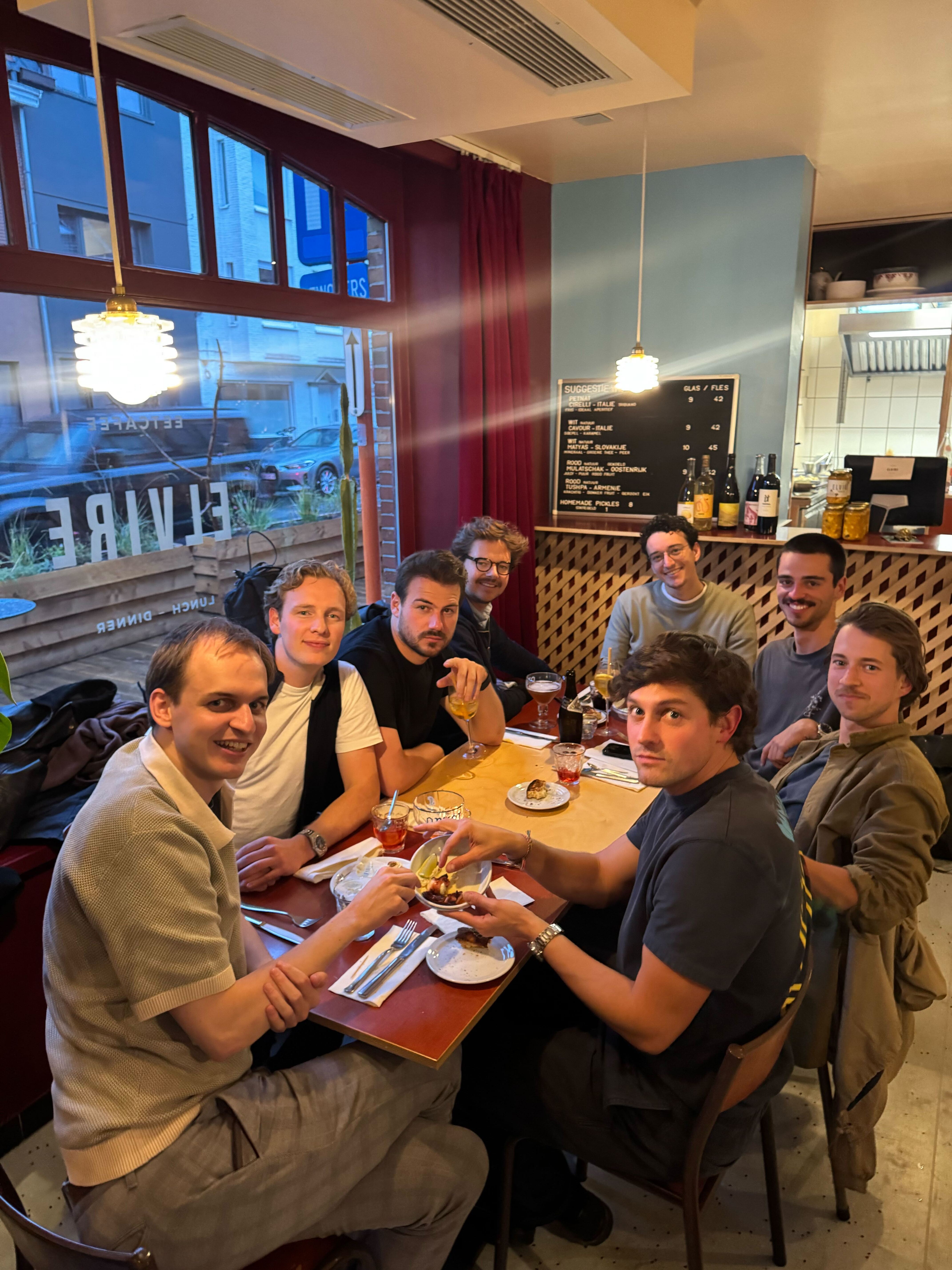A group pictured at a restaurant table on Tekst’s careers website