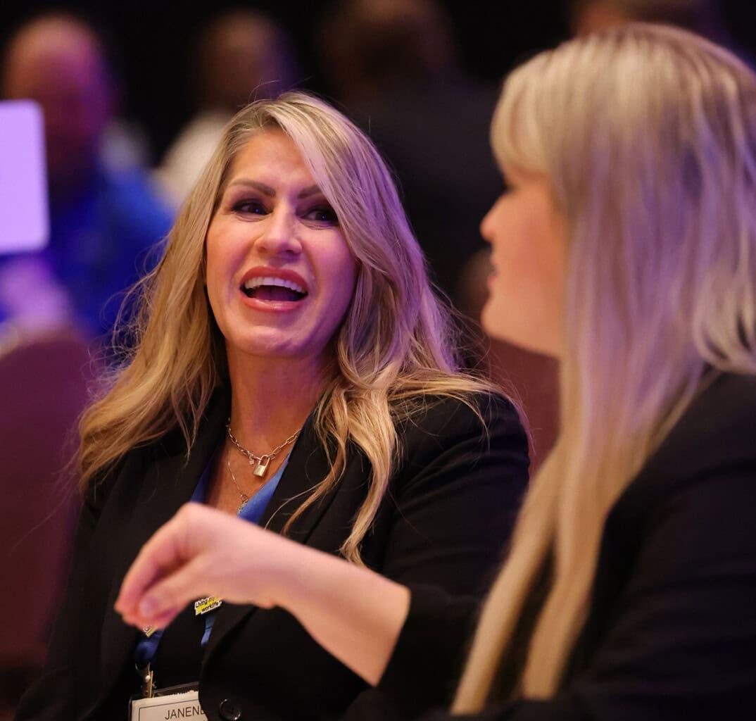 Two attendees in conversation at a Telarus event