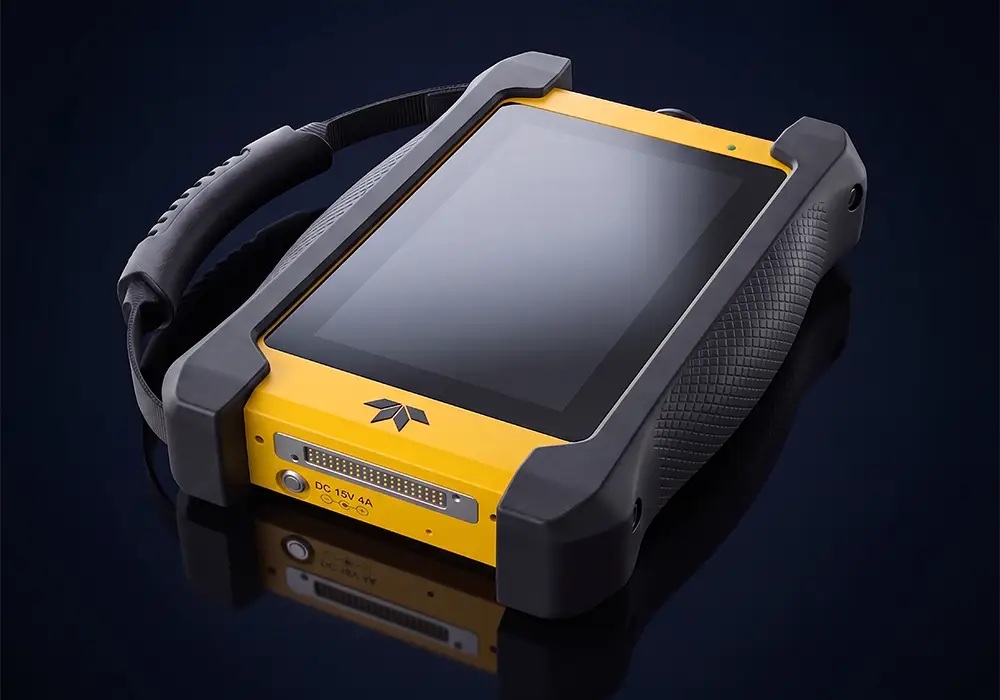 Yellow and black Teledyne PMAT XS portable aircraft software loader with touchscreen and carrying handle