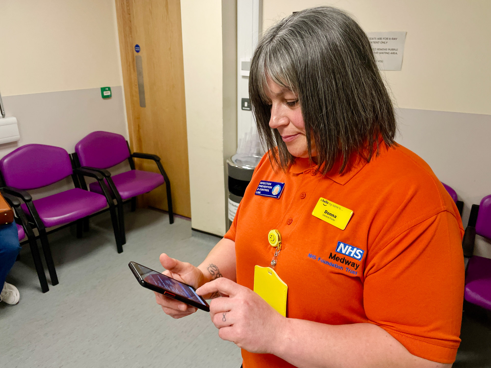 A Medway hospital porter checks a handheld device for an assigned job