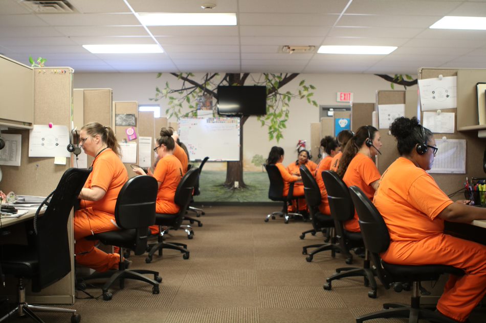 Televerde employees wearing headsets at cubicles inside an Arizona prison contact center