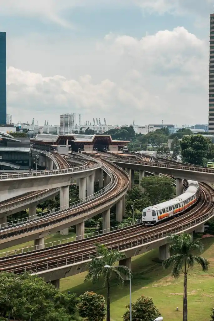 A metro train on elevated tracks above a city