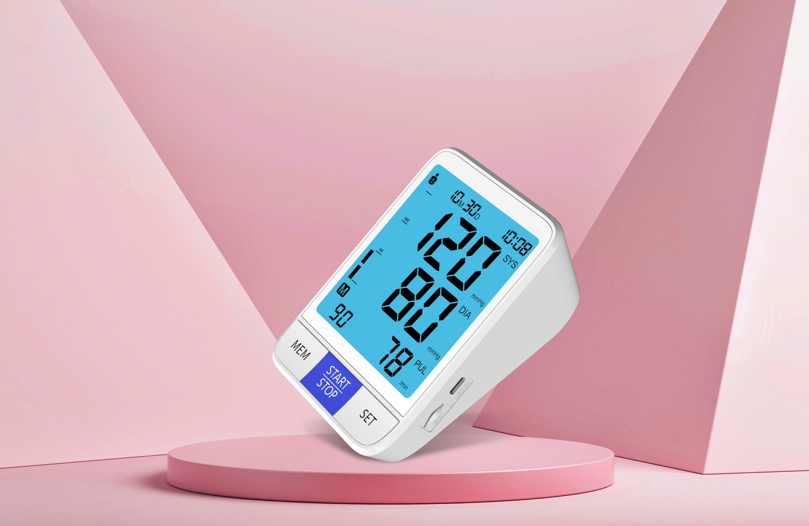 Tellihealth blood pressure monitor with a blue display, photographed against pink geometric panels