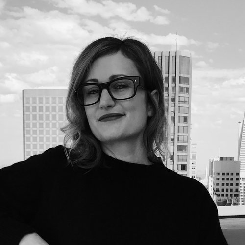 Tempest founder Holly Whitaker wearing glasses, photographed against a city skyline