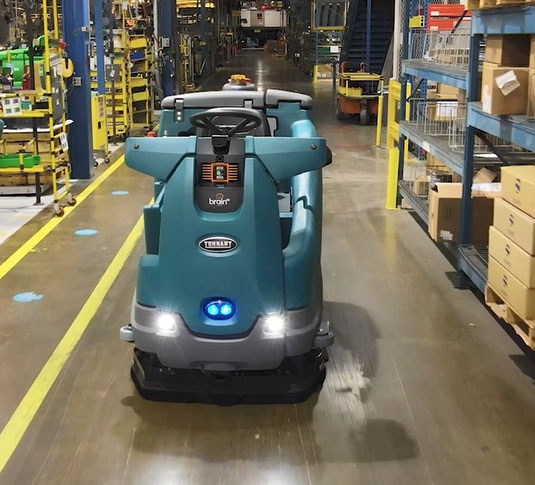 Tennant T16AMR industrial robotic floor scrubber in a manufacturing setting