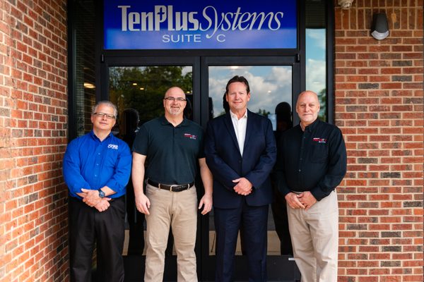 Four TenPlus Systems team members outside the Raleigh office