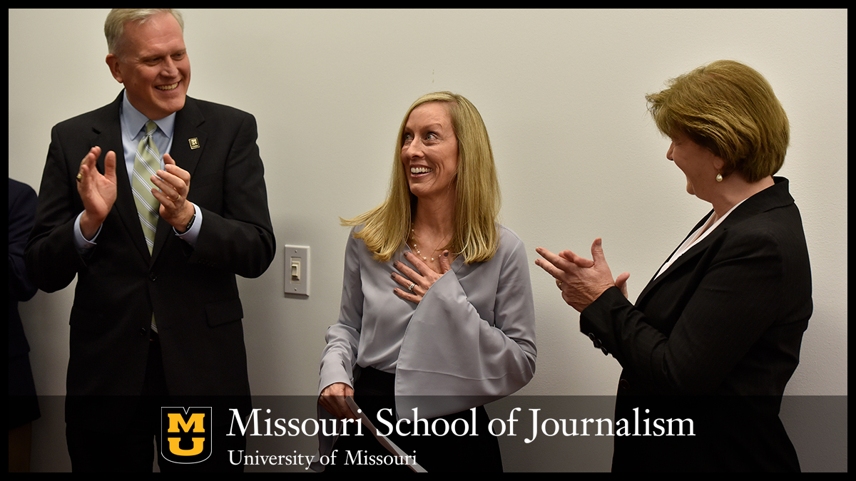 Teresa Maledy, right, applauds alongside dean David Kurpius as Shelly Rodgers receives teaching recognition.