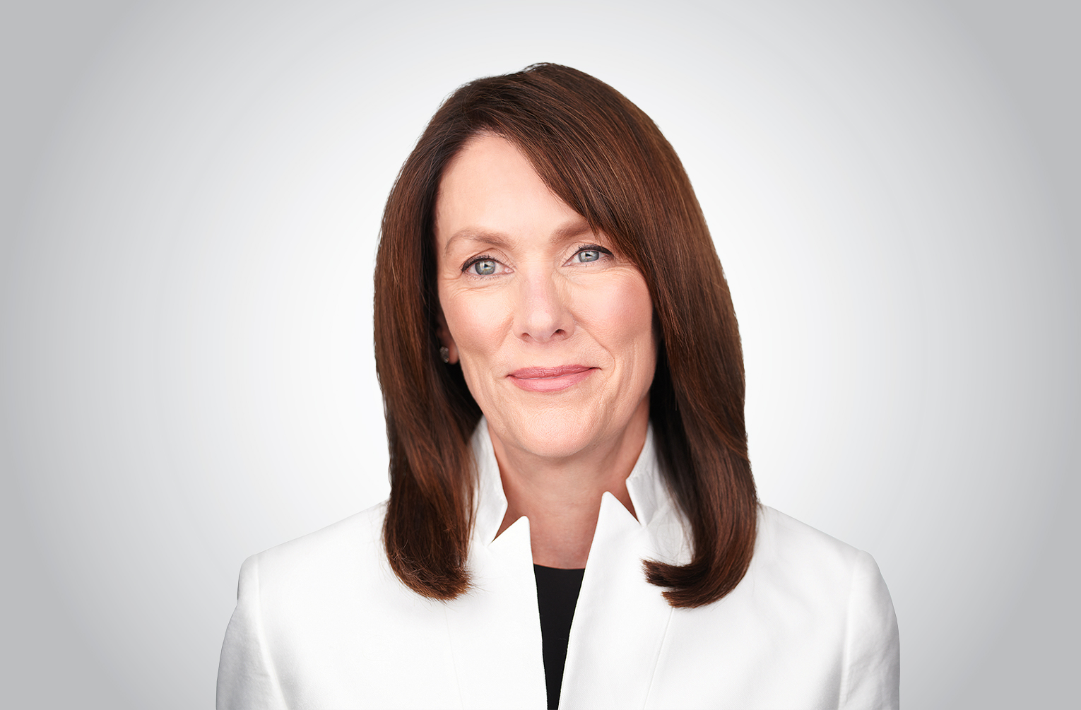Teresa Poggenpohl in a white jacket against a gray background