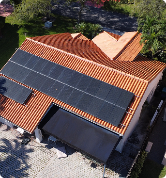 Aerial view of a Miami home with rooftop solar panels on a terracotta roof
