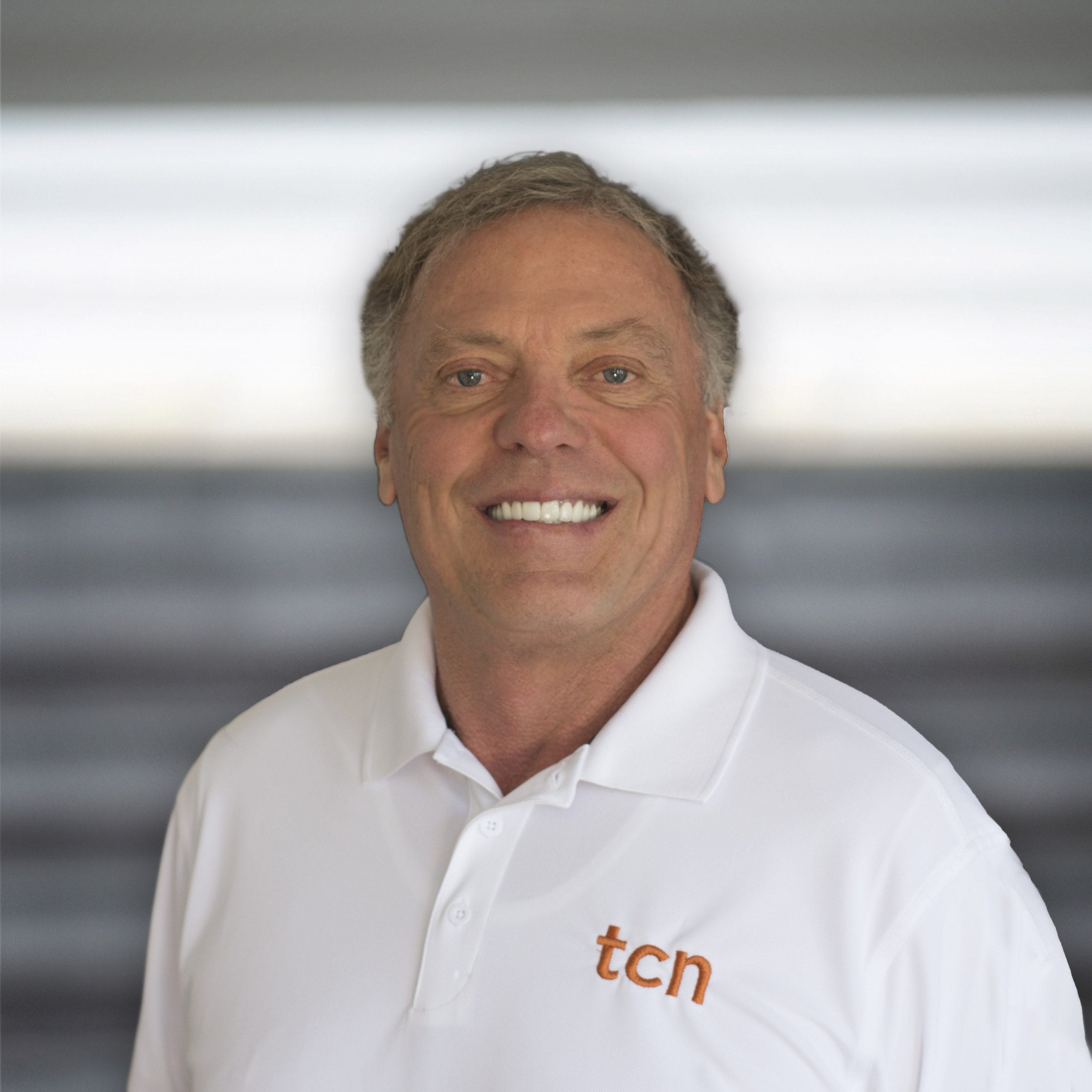 Terrel Bird smiling in a white TCN polo in an earlier company publicity photograph
