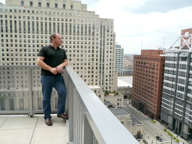 Terry Howerton standing on the TechNexus rooftop deck overlooking downtown Chicago