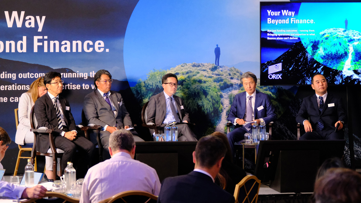 Five ORIX executives seated on a stage in London, with Terry Suzuki fourth from the left