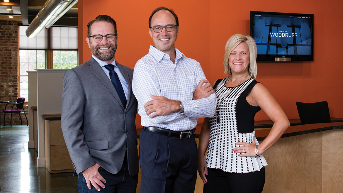 Terry Woodruff, center, with two agency colleagues in 2017