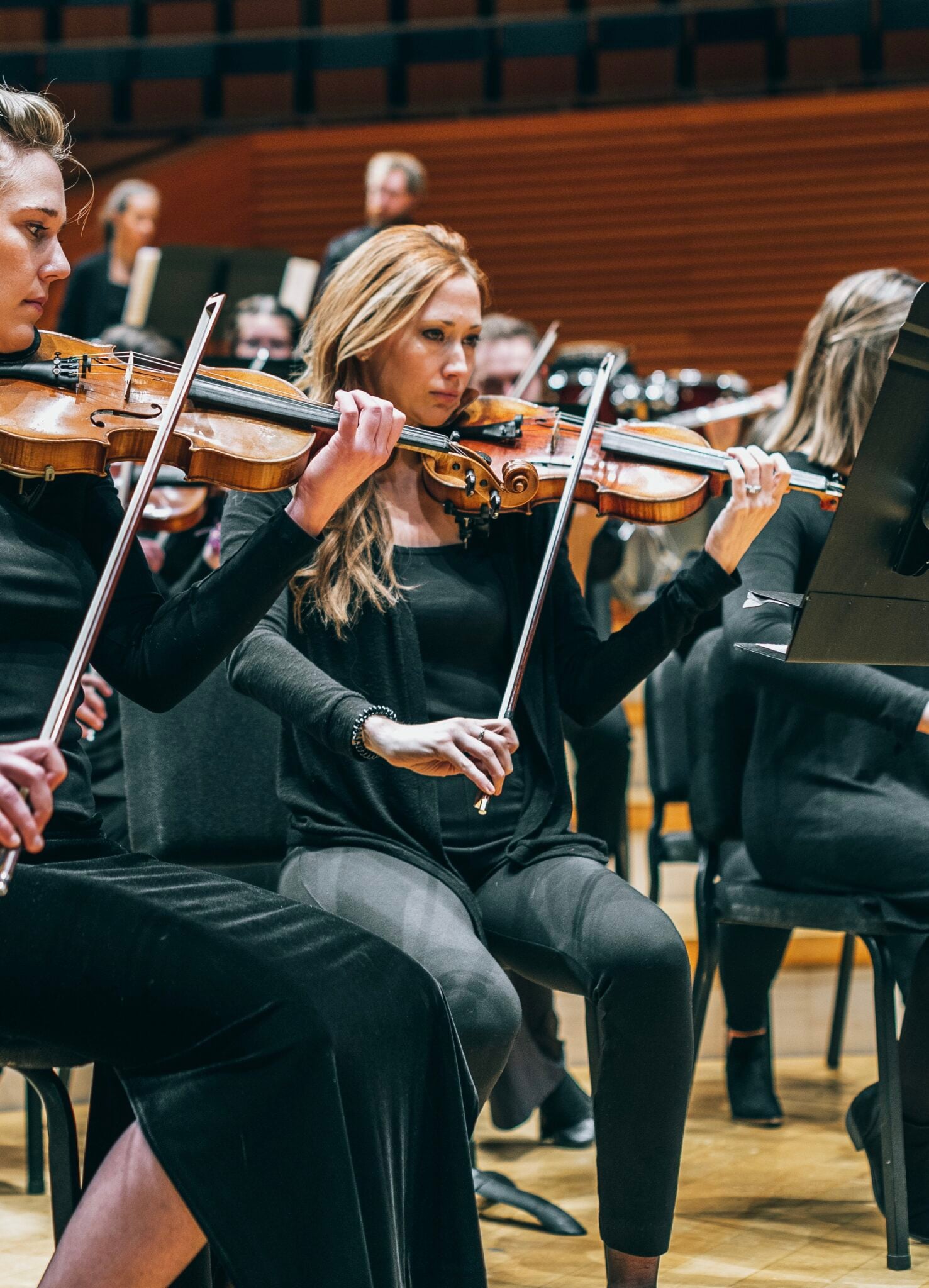 Tessa Fisher playing violin in an orchestra