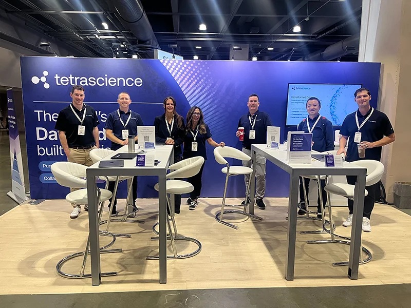 Seven TetraScience team members standing at a company exhibition booth