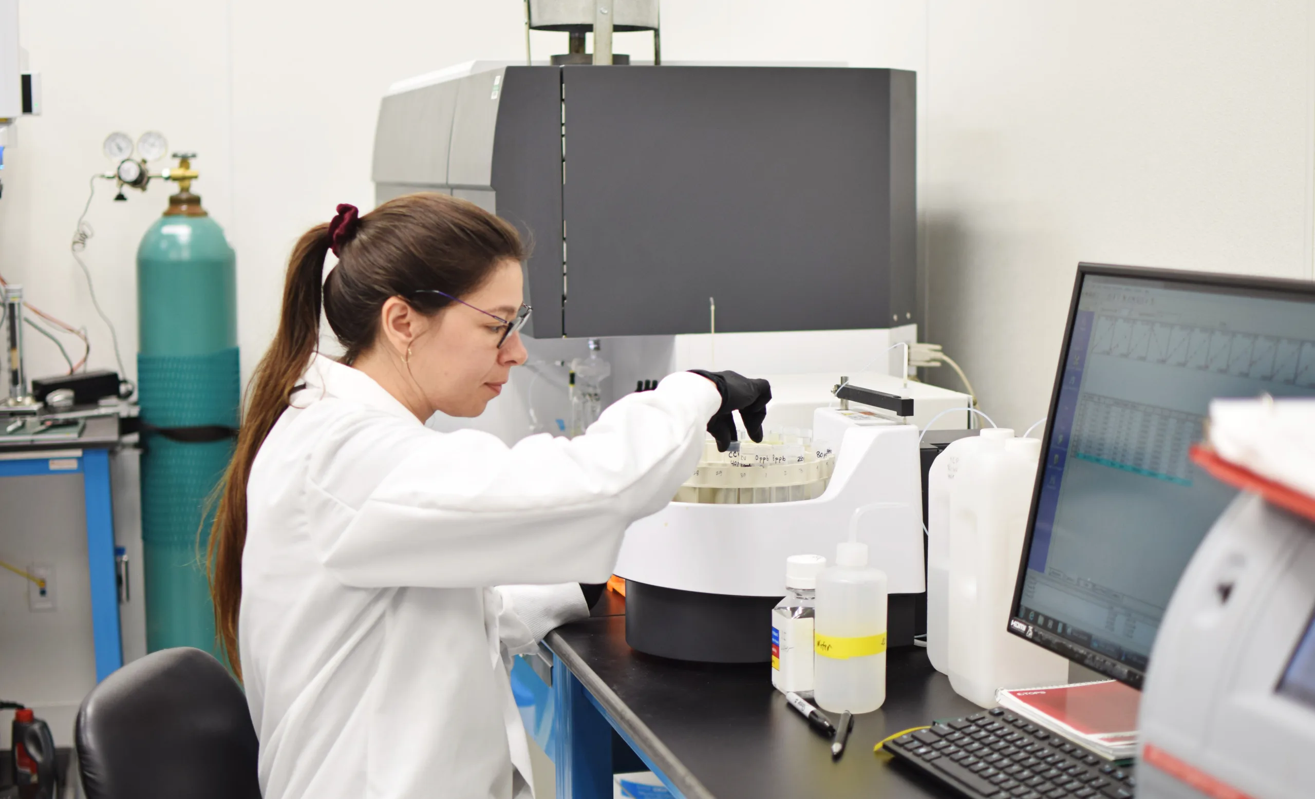 A laboratory employee works at Texas Original testing equipment