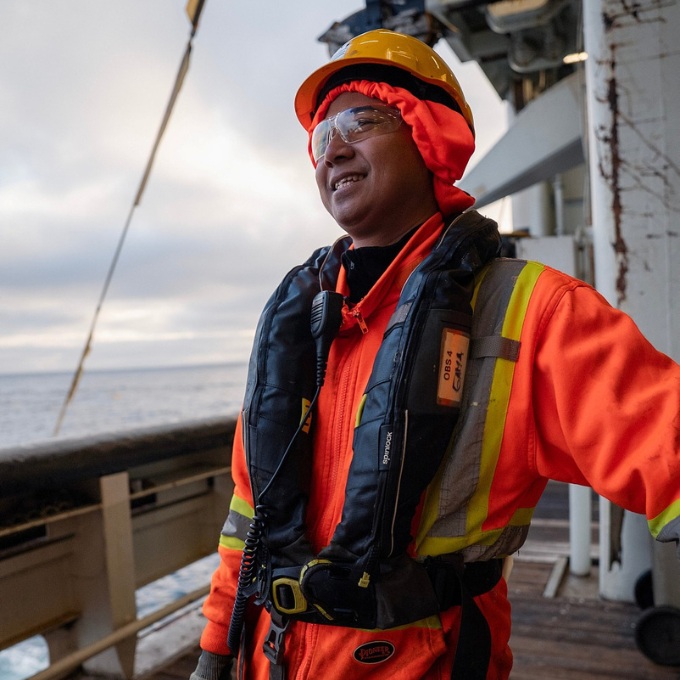 A crew member wearing safety equipment aboard a Ramform vessel