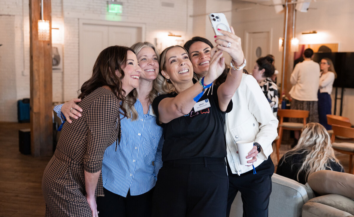 Four women taking a selfie at an Amy Porterfield business event