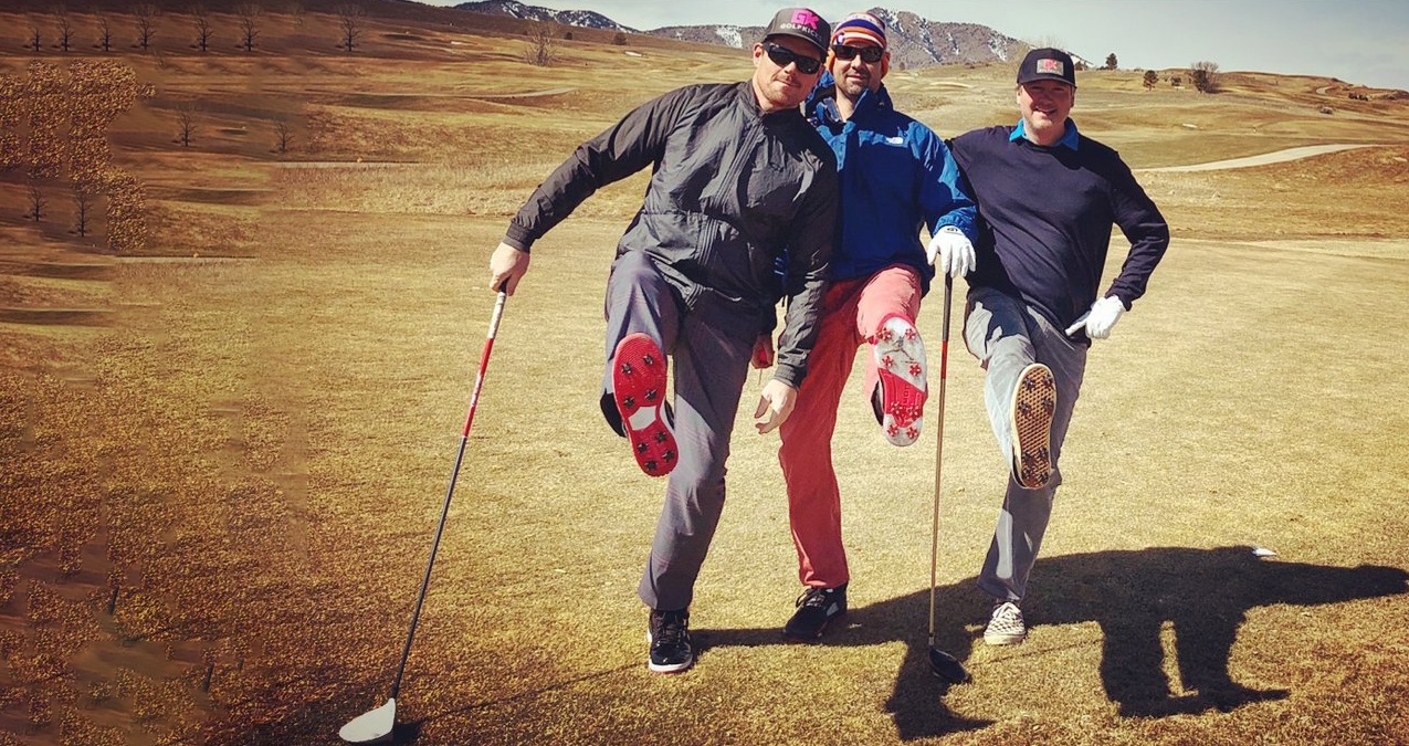 Three Golfkicks founders on a golf course showing the cleats on their shoes