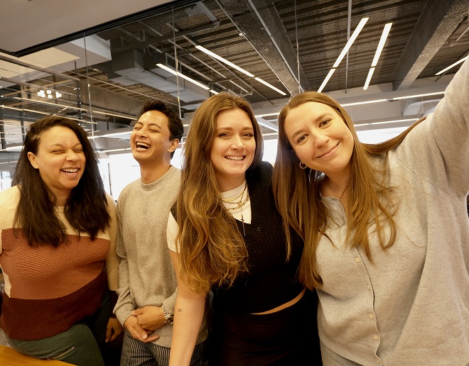 Four members of The Bloc team smiling together in an office