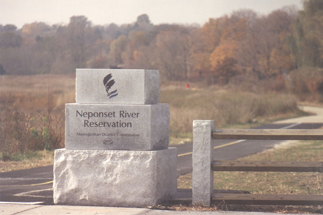 A green section of the Neponset River Greenway beside the water
