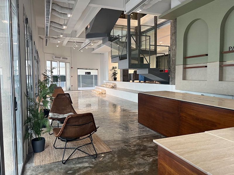 The Collective Hub Yateem Centre lobby with a glass staircase, long windows and seating