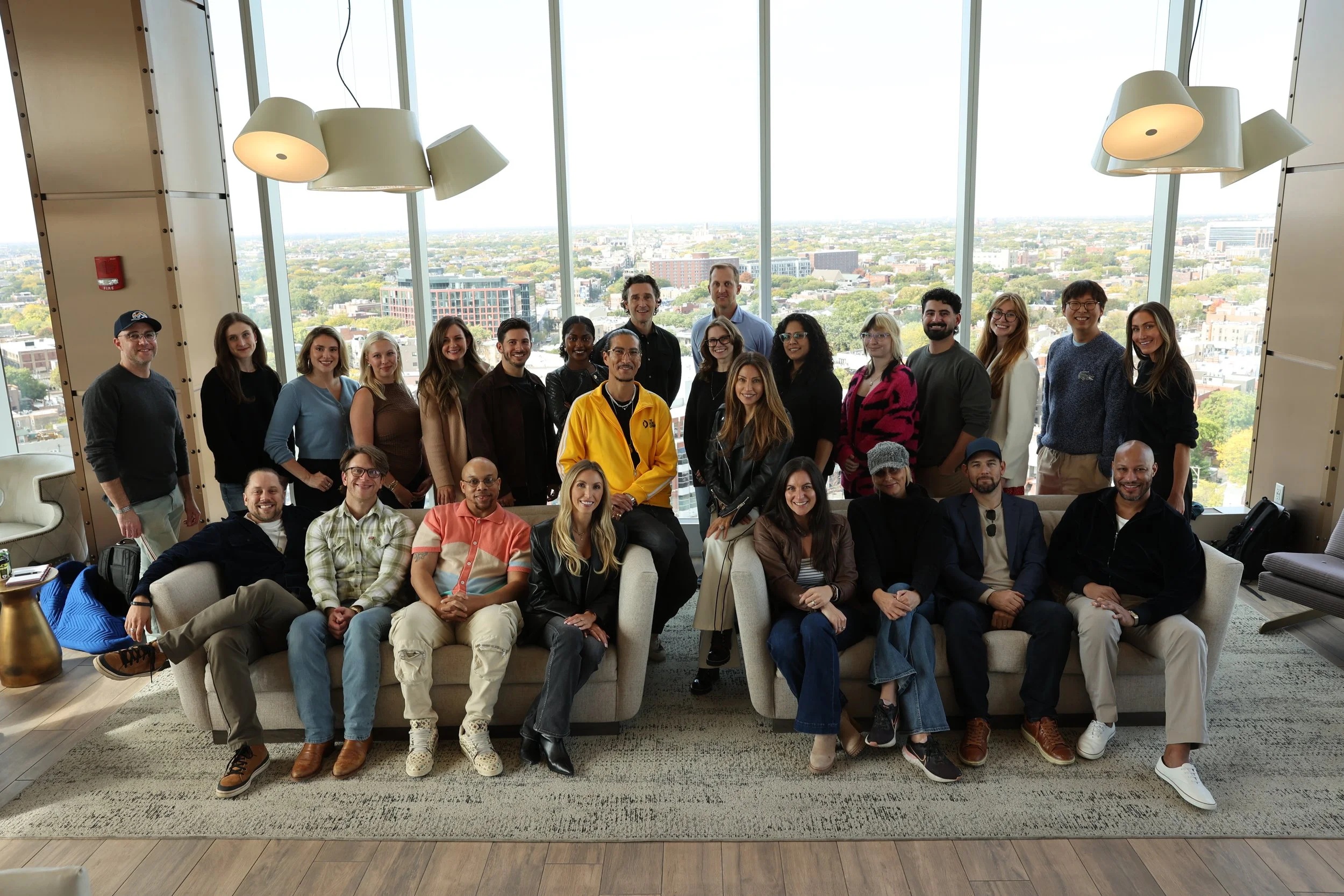 The Desire Company team gathered around a sofa in a bright room