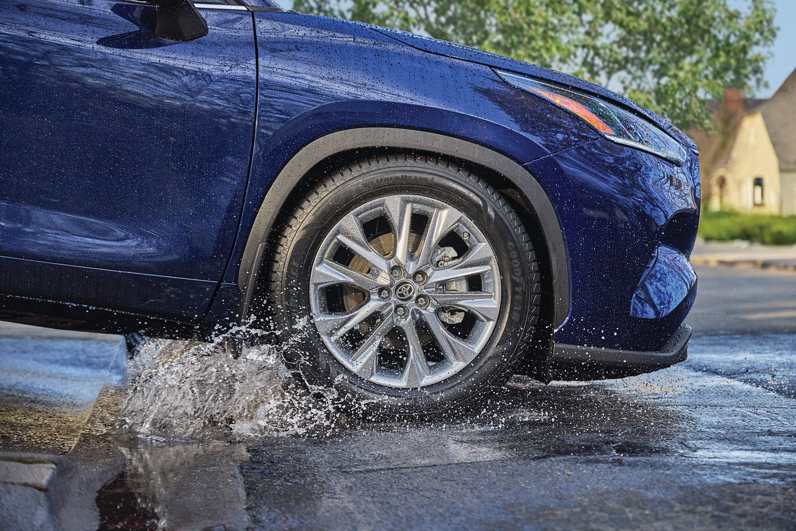 Goodyear Assurance WeatherReady 2 tire photographed splashing through water