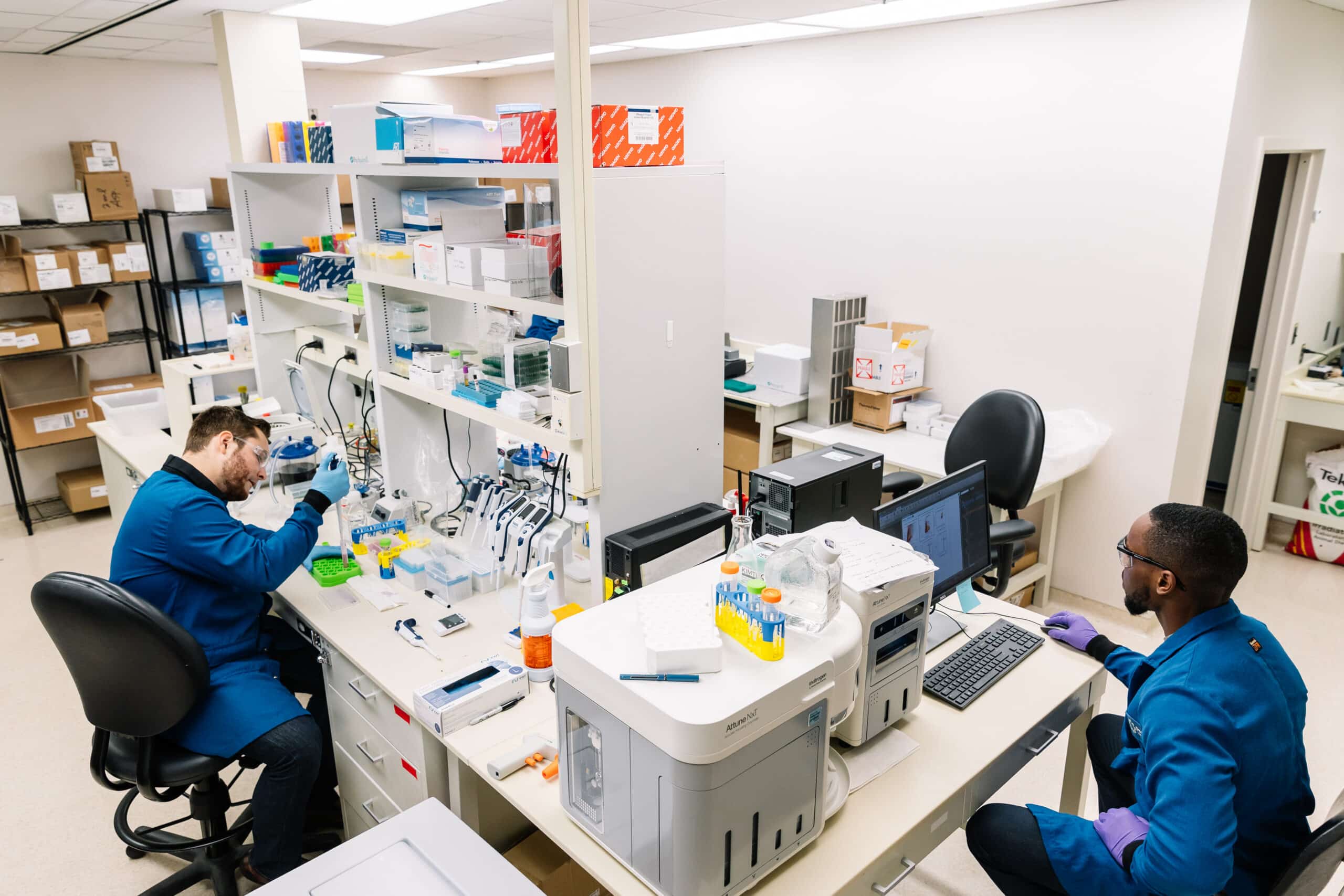 Two scientists working at a fully equipped Innovation Space laboratory bench