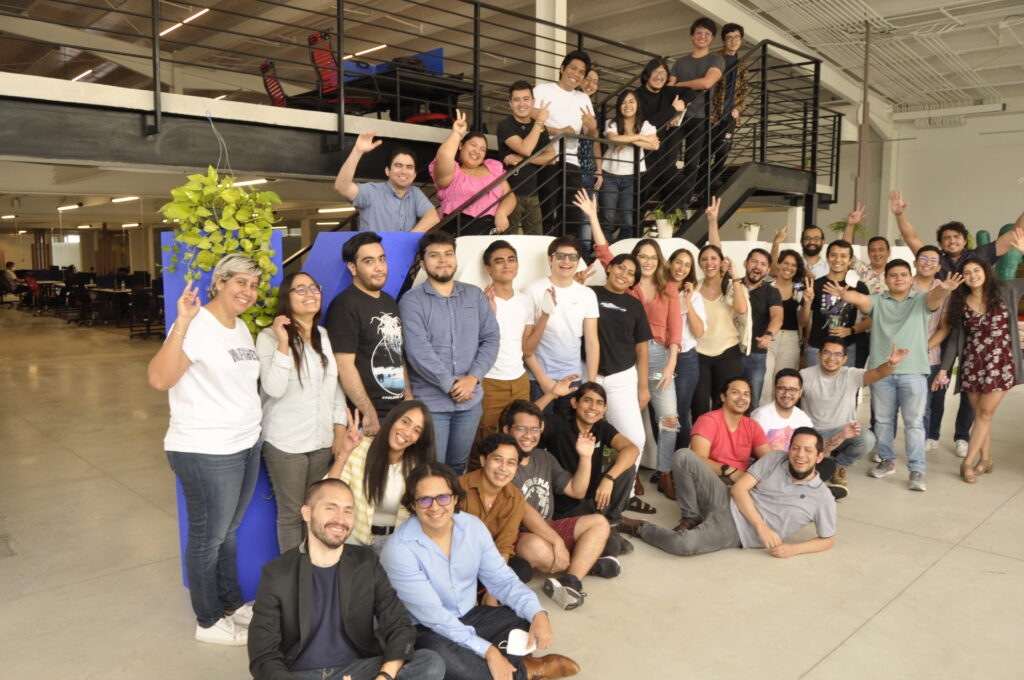 Ksquare colleagues gathered across an office floor and staircase