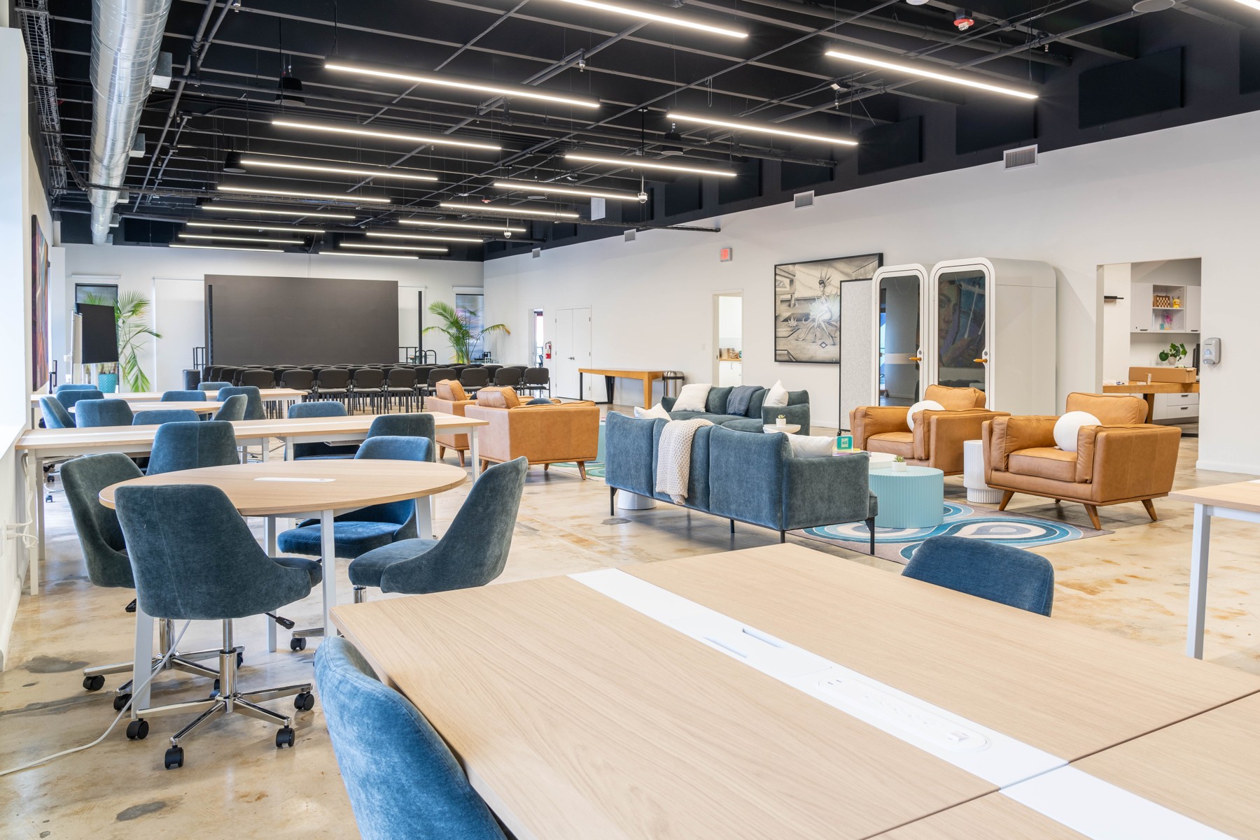 The LAB Miami interior with communal tables, sofas, phone booths and event seating