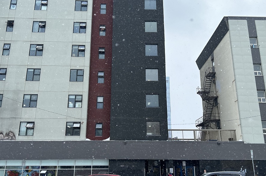 Multi-storey supportive housing building in downtown Saskatoon during snowfall
