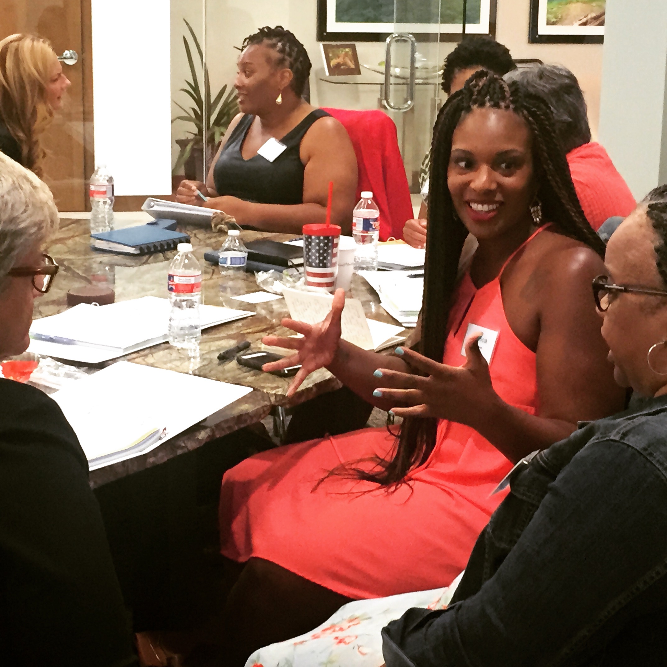 Participants in an OpEd Project workshop exchanging ideas around a table