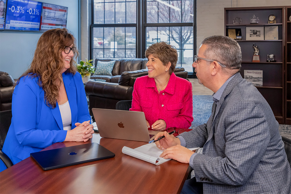 Members of The Perry Group gathered in a bright office