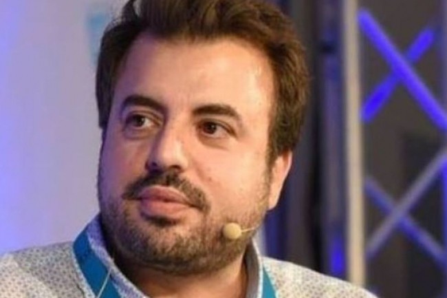 The Refiners co-founder Carlos Diaz speaking with a headset microphone