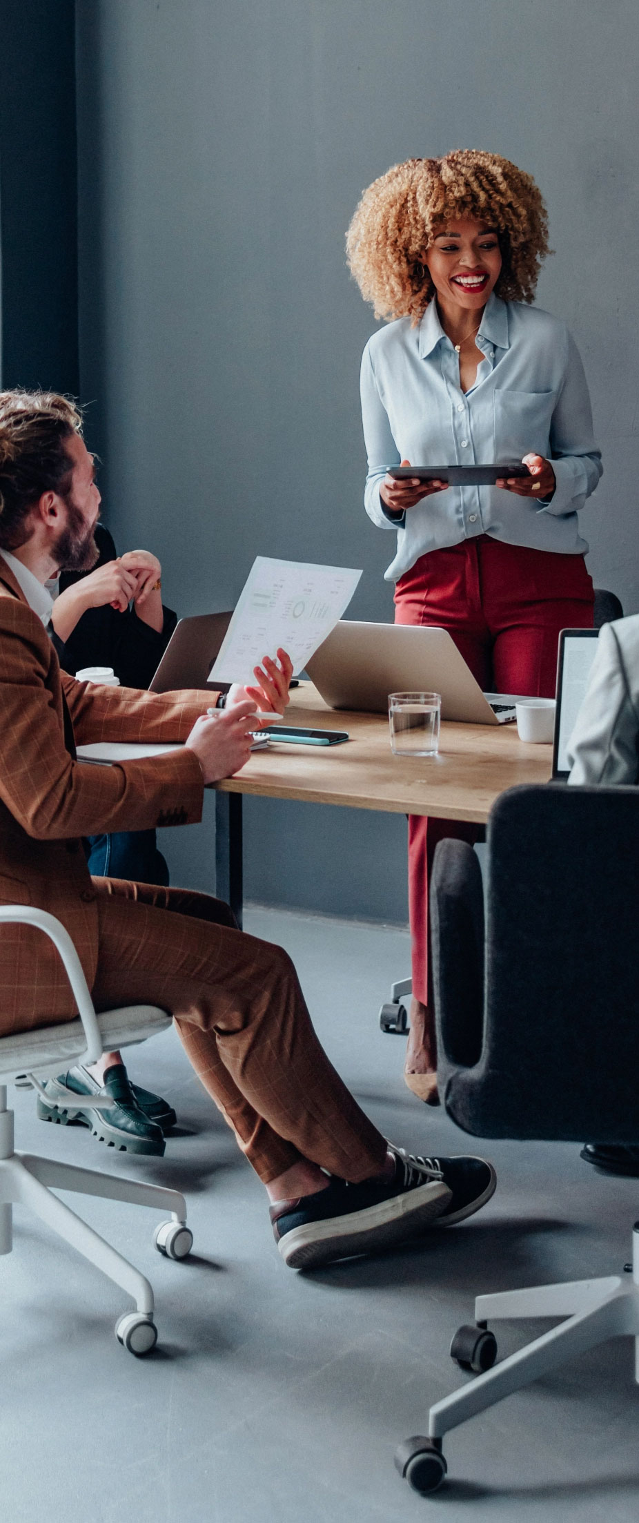 A small team discussing a chart around a conference table