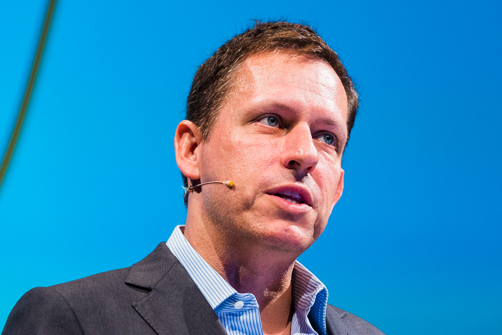 Peter Thiel speaking into a microphone at the Hy! Summit in Berlin in 2014