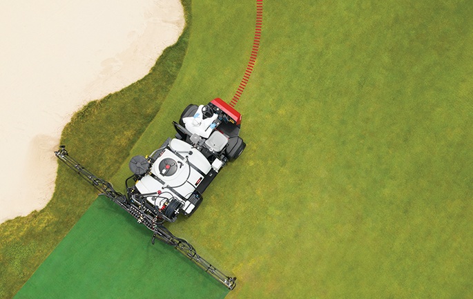 Overhead view of a Toro sprayer following the edge of a golf bunker