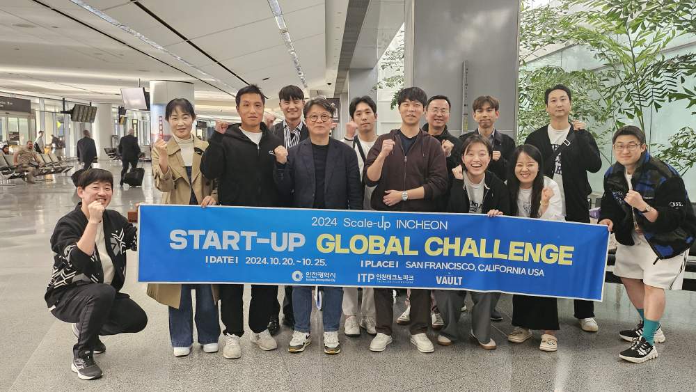 Participants pose with the blue 2024 Scale-up Incheon Startup Global Challenge banner