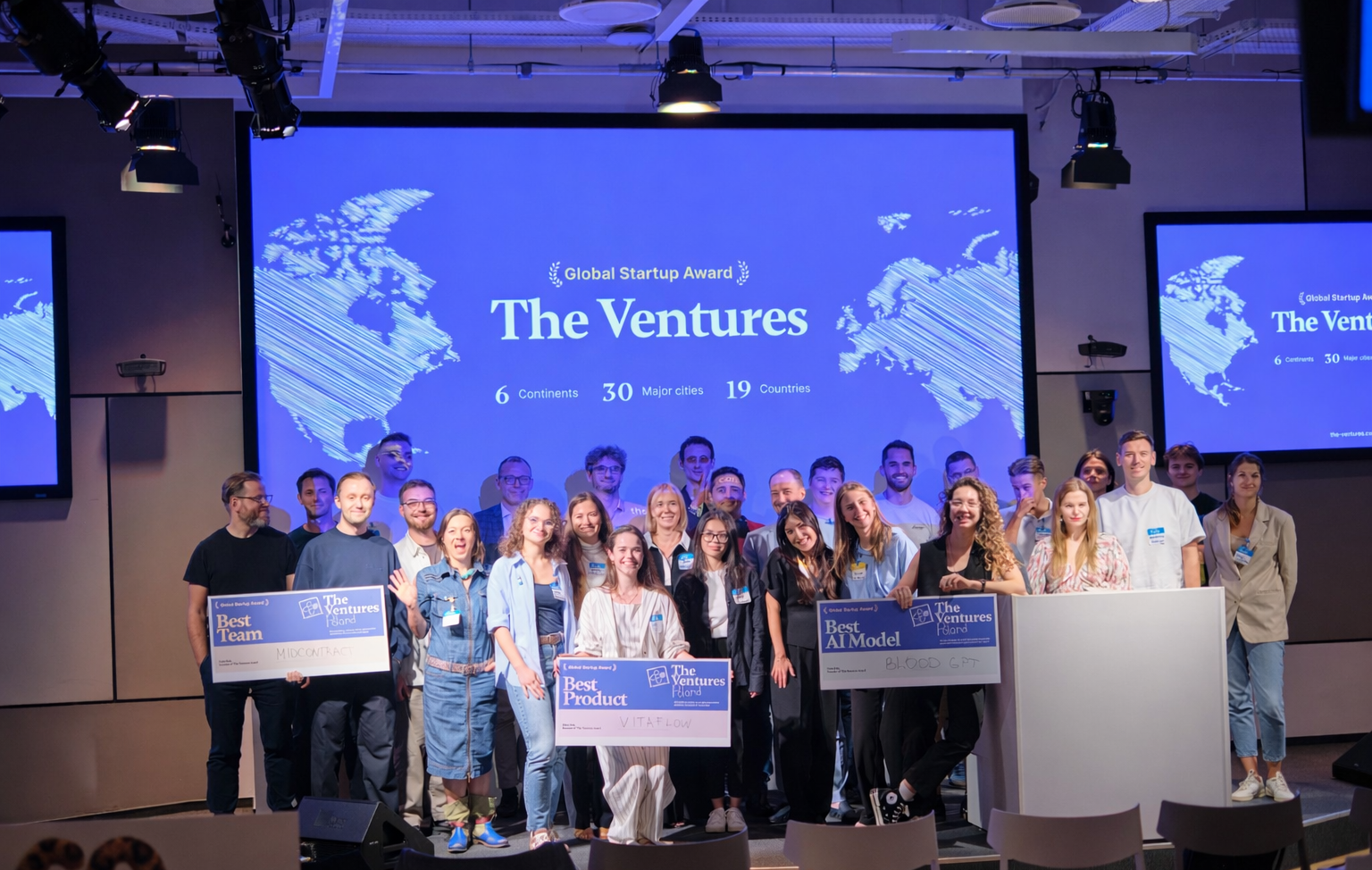 Award recipients and participants gathered on a The Ventures stage