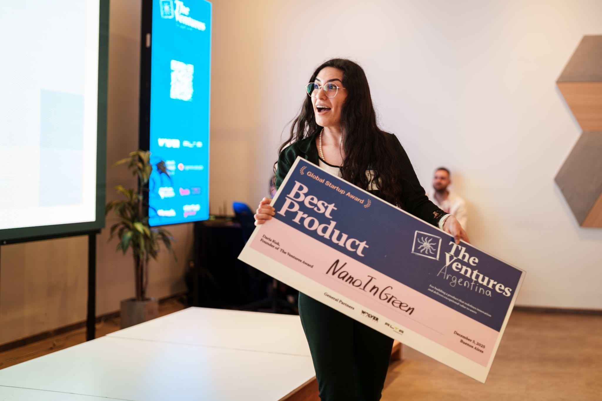 A founder holding a Best Product award at a The Ventures event
